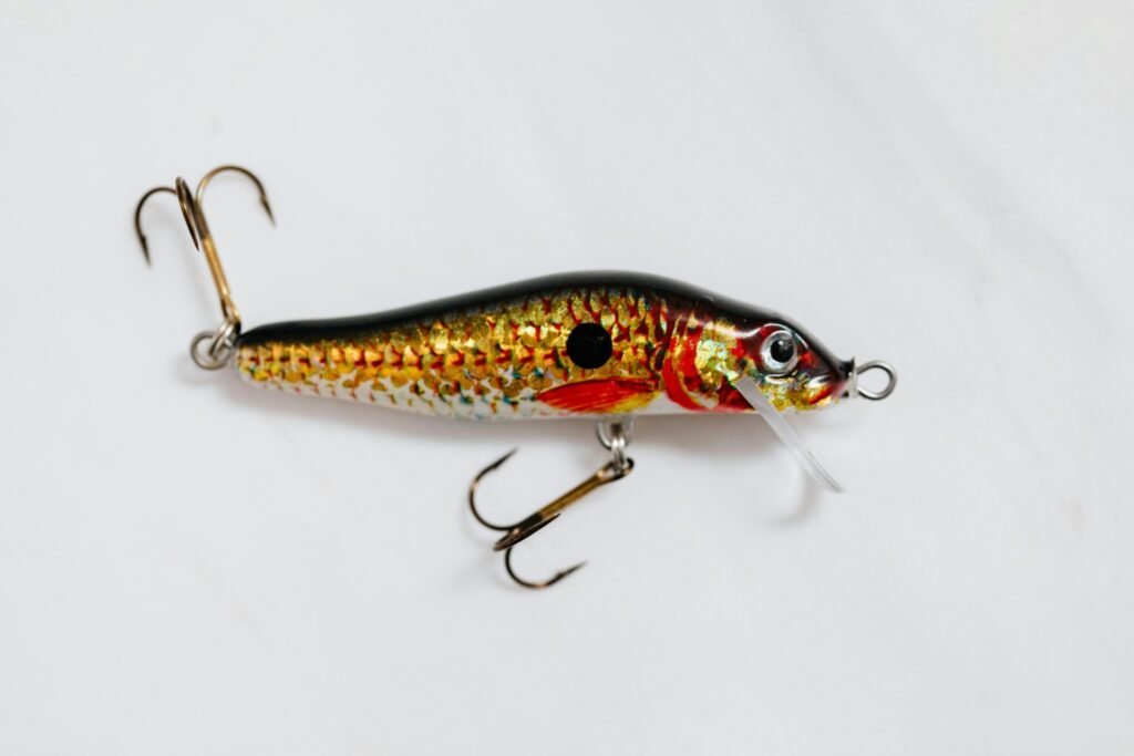 Fishing lure crankbait with treble hooks used to demonstrate proper lure retrieval techniques